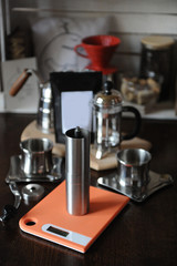 The process of brewing coffee. Coffee grinder on scales, french press and drip maker. Pack with blank label