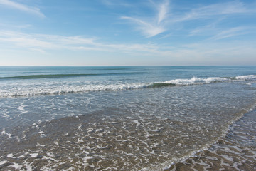 waves, sea and sun reflecting from the beach - background