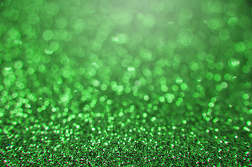 Green bright abstract bokeh background. Sparkle texture for birthday card or christmas, new year, Saint Patrick's Day, party and other holidays invitation backdrop.