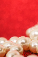 Pile of pearls on red christmas background