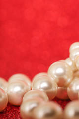 Pile of pearls on red christmas background