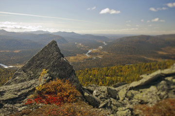 Fototapeta na wymiar Ural autumn landscape - snow-capped peaks, mountain forests, yellow foliage, transparent cold rivers