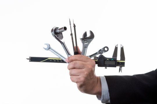 Mechanic engineer holding many kind of tool in his hand; handing tool on white background