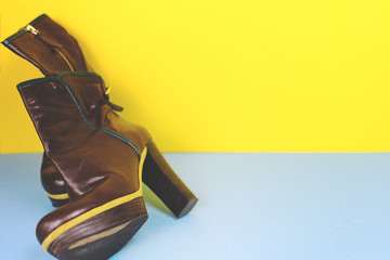 Ankle boots on a colored background