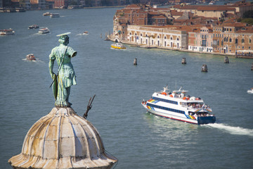 Aerial view of Venice lagoon and San Giorgio Maggiore dome with statue from the top of Campanile © tanaonte