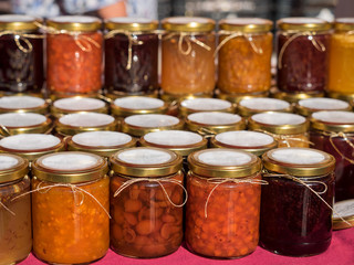 Different wild fruits jam in a market, natural organic food preserve for winter 