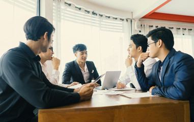 Asain business people are using gadgets, talking and smiling during the conference in office. Corporate Teamwork Partnership in an Office Meeting,Design Ideas business planning concepts,vintage color