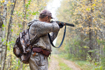 hunter taking aim from a shotgun in the wildfowl