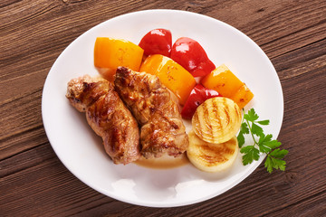 Grilled meat rolls with vegetables on wooden background