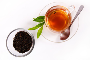 cup with tea and green leaf