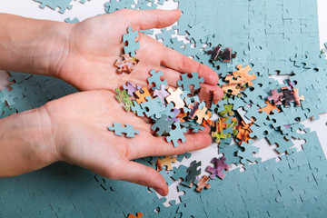 pile of puzzles in the hands
