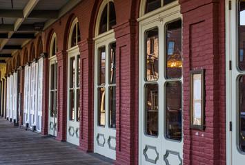 Wooden Sidewalk In Front Of Historic Building Doors