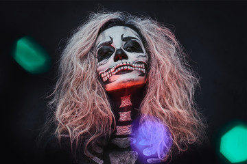 Halloween female skull makeup with creative lightening.