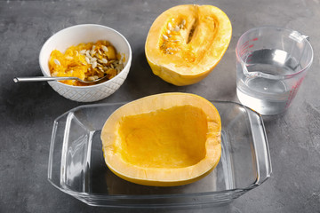 Cut spaghetti squash in baking dish on table