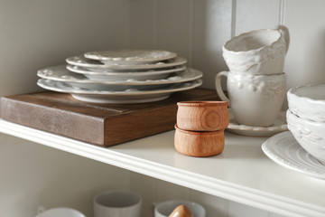Storage stand with tableware indoors