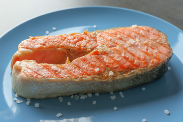 Delicious salmon steak on plate, closeup