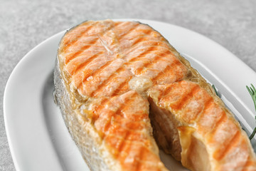 Delicious salmon steak on plate, closeup