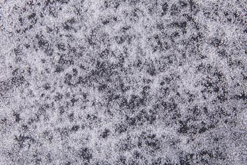 Texture of white sugar crystals on a black background