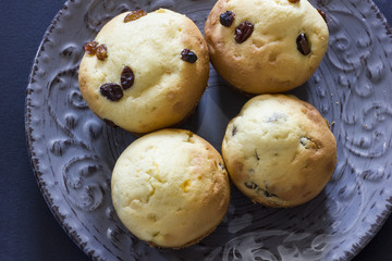 Tasty vanilla muffins on an ornamented plate