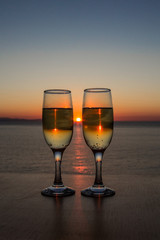 Two glasses of wine at sunset on the table