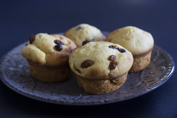 Tasty vanilla muffins on an ornamented plate