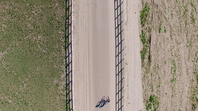 Top down stationary aerial drone view of cyclists on a country road in California