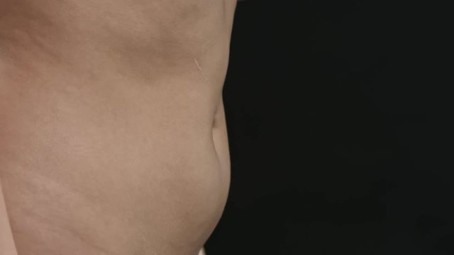 Bellyache, severe abdominal pain, woman holding her belly and having painful cramps.