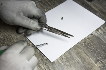 master man holding a pair of scissors and going to sharpen them