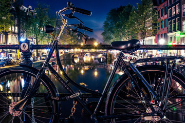 bike in amsterdam by night on the canals