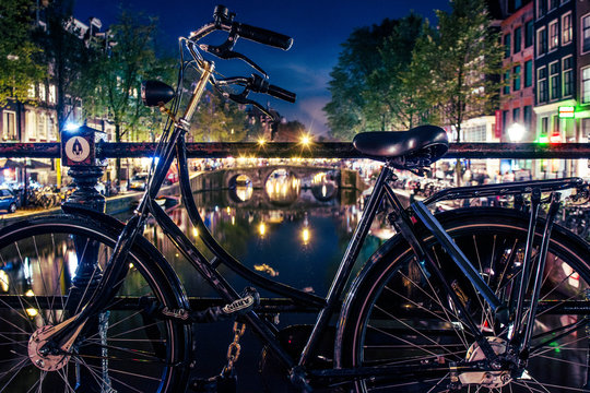 Bike In Amsterdam By Night On The Canals