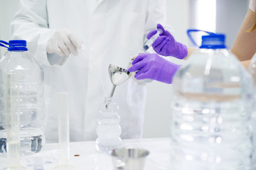 Close up of two scientists checking the quality of water in the laboratory.
