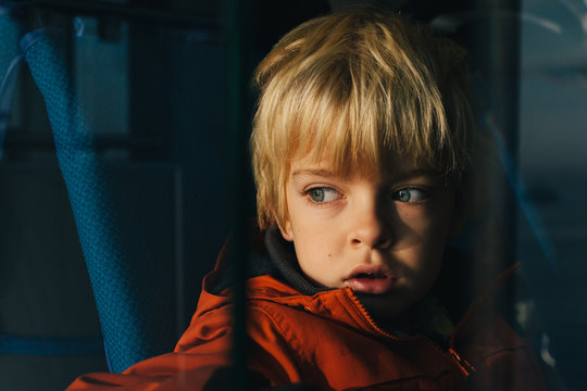 Boy gazes out to sea while on a ferry.
