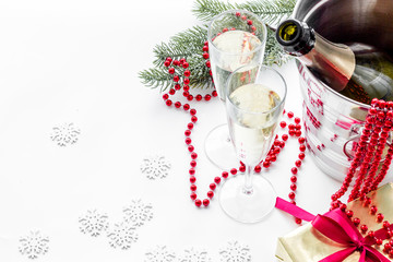 New Year 2018 background. Champagne in bucket, glasses with beverage, spruce branch and decoration on white background copyspace