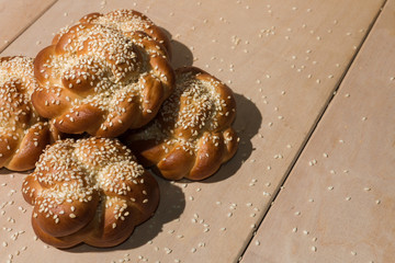 Buns with sesame seeds on a wooden background