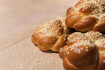 Buns with sesame seeds on a wooden background