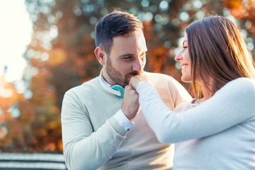 Happy couple in love having fun outdoors and smiling.