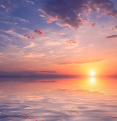 Fototapeta na wymiar Beautiful sunset over calm water.