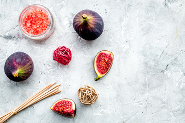 organic cosmetic set with fresh fig, bath salt and scrub on stone background flat lay mock-up