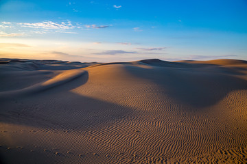 Obraz na płótnie Canvas Natural beautiful desert landscape, sand dunes on blue evening sky background