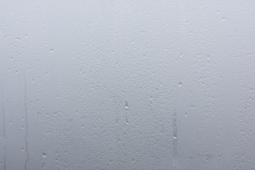 Natural Water Drops on Glass, Window Glass With Condensation, Strong, High Humidity, Large Drops of Water Flow Down the Window