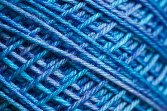 Macro of variegated blue spool of yarn