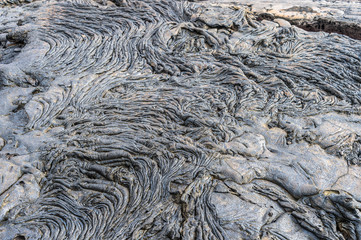 Pahoehoe or rope lava, on Rabida Island, Galapagos. It is formed of igneous rock, which create bizarre patterns as it cools known as lava sculpture.