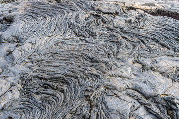 Pahoehoe or rope lava, on Rabida Island, Galapagos. It is formed of igneous rock, which create bizarre patterns as it cools known as lava sculpture.