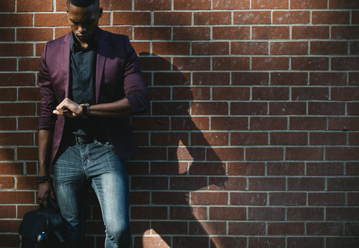 Young businessman checking the time
