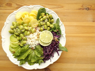 Vegetarian buddha bowl. Cooked rice, beans, edamame and raw fresh vegetables