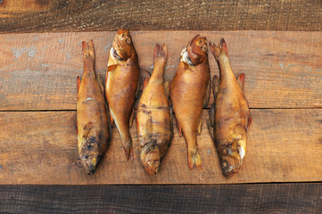 Medium-sized fish perch caught in a small river far from the city and plants, clogged with cherry...
