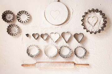 Holiday baking utensils still life of holiday baking utensils heart cookie cutters vintage flourish background empty