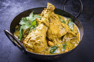 Traditional Indian curry chicken as close-up in a Korai