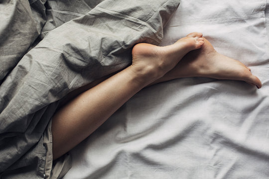 Woman's Legs in Bed