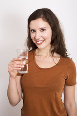 young woman holding a glass of water